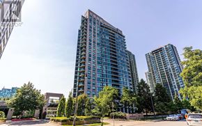 Toronto (Willowdale East) condo for rent - A tall building with blue glass windows stands in front of a smaller building and trees.