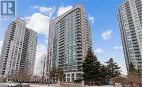 Toronto (Willowdale East) condo for rent - A tall building with a glass facade stands in front of two other buildings.
