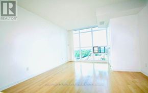 Toronto (Willowdale East) condo for rent - A large empty room with wooden floors and a large window.