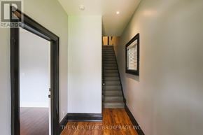 Toronto (North Riverdale) apartment for rent - A hallway with a staircase and a painting on the wall.