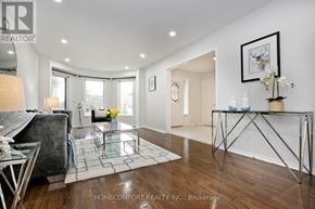 Mississauga (Central Erin Mills) apartment for rent - A modern living room with a glass coffee table and a grey sofa.