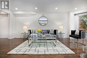 Mississauga (Central Erin Mills) apartment for rent - A modern living room with a glass coffee table and a black and white sofa.