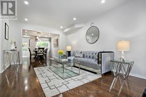 Mississauga (Central Erin Mills) apartment for rent - A modern living room with a glass coffee table and a grey sofa.