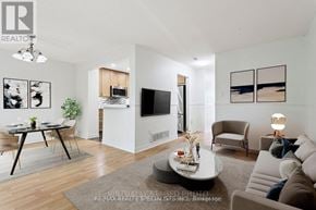 Mississauga (Erin Mills) townhouse for rent - A modern living room with a flat screen TV, a coffee table, and a dining table.