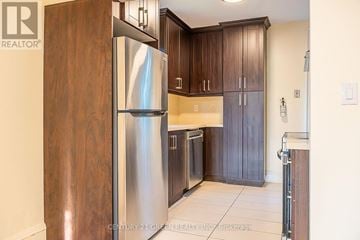 Hamilton (Westdale) apartment for rent - A kitchen with a stainless steel refrigerator and wooden cabinets.