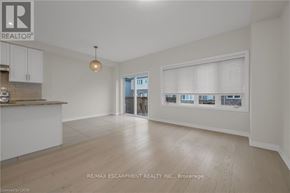 Lincoln (Beamsville) townhouse for rent - A spacious room with wooden flooring and a large window with blinds.