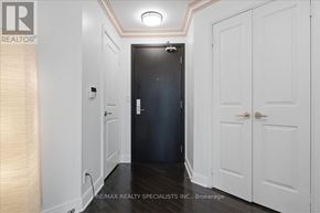 Mississauga (City Centre) condo for rent - A hallway with a black door and white walls.