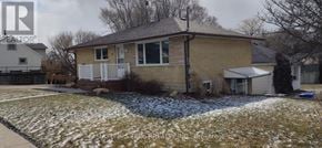 Guelph (St. George's) apartment for rent - A house with a brown brick exterior and a white porch.
