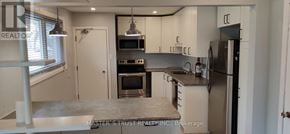 Guelph (St. George's) apartment for rent - A kitchen with a refrigerator, oven, and microwave.