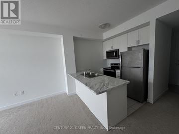 Hamilton (Waterdown) condo for rent - A kitchen with white cabinets and a marble island.