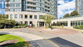 Toronto (Willowdale East) condo for rent - A large building with a circular driveway in front of it.