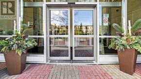 Toronto (Willowdale East) condo for rent - Two brown pots with plants in front of a glass door.