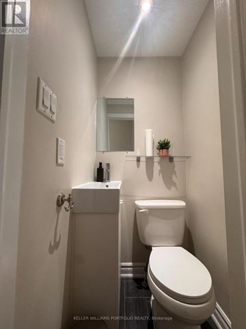 Toronto (Mount Pleasant West) apartment for rent - A white toilet in a small bathroom with a white sink and a mirror.