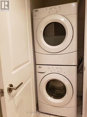 Toronto (Niagara) condo for rent - Two white front loading washing machines in a small laundry room.