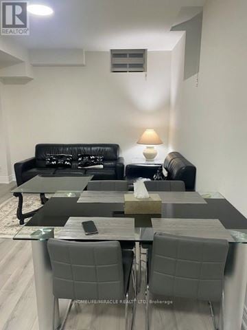 Bradford West Gwillimbury (Bond Head) apartment for rent - A modern living room with a black sofa and grey chairs.