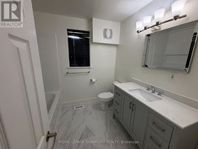 Mississauga (Mississauga Valleys) apartment for rent - A bathroom with a sink, toilet, and mirror.