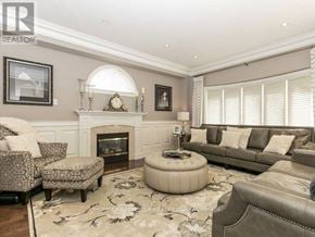 Brampton (Vales Of Castlemore North) apartment for rent - A living room with a fireplace and a couch.