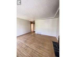 Burnaby apartment for rent - A room with wooden flooring and a white wall.