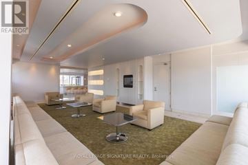 Toronto (Church-Yonge Corridor) condo for rent - A spacious living room with a white sofa set and a television.