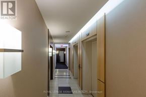 Toronto (Church-Yonge Corridor) condo for rent - A hallway with doors on the right and a sign that says Royal LePage Signature Realty, Brokerage.