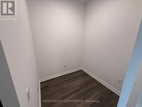 Vaughan (Vaughan Corporate Centre) condo for rent - A room with a wooden floor and white walls, with a logo for Orion Realty Corporation in Brokerage.