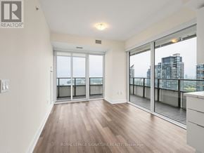 Toronto (Mimico) condo for rent - A spacious room with wooden flooring and sliding glass doors leading to a balcony.
