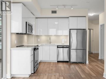 Toronto (Mimico) condo for rent - A kitchen with white cabinets and stainless steel appliances.