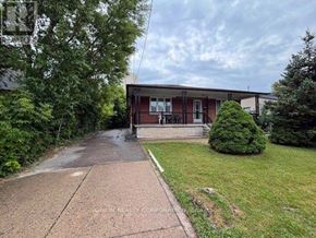 Toronto (Yorkdale-Glen Park) apartment for rent - A house with a brick driveway and a green lawn.