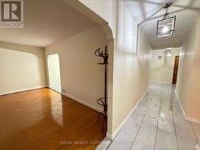Toronto (Yorkdale-Glen Park) apartment for rent - A hallway with a wooden floor and white walls.