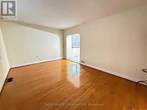 Toronto (Yorkdale-Glen Park) apartment for rent - A room with wooden flooring and white walls, with a window on the right.