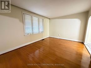 Toronto (Yorkdale-Glen Park) apartment for rent - A room with wooden flooring and a window with blinds.