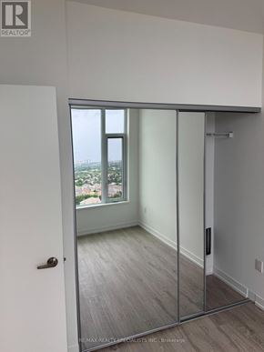 Mississauga (Central Erin Mills) condo for rent - A room with a sliding glass door leading to a balcony.