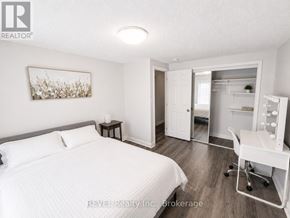 St. Catharines (Lakeport) apartment for rent - A bedroom with a bed, desk, and chair.
