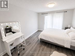St. Catharines (Lakeport) apartment for rent - A bedroom with a bed, a vanity table, and a chair.
