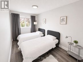 St. Catharines (Lakeport) apartment for rent - Two beds in a room with REVEL Realty Inc. logo.