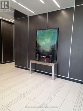 Toronto (Lansing-Westgate) condo for rent - A modern office lobby with a flat screen TV mounted on the wall.