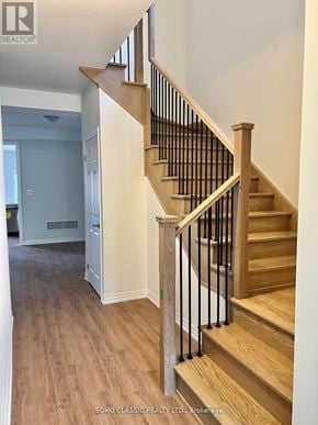 Georgina (Keswick North) apartment for rent - A wooden staircase with a metal railing in a house.