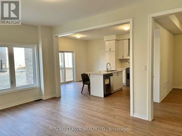 Georgina (Keswick North) apartment for rent - A kitchen area with a dining table and chairs is visible from the living room.