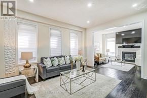 Bradford West Gwillimbury (Bradford) apartment for rent - A well-lit living room with a grey sofa and a glass coffee table.