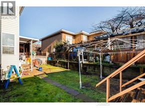 Richmond apartment for rent - A backyard with a playground and a house in the background.