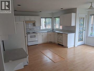 Richmond apartment for rent - A kitchen with white cabinets and a wooden floor.