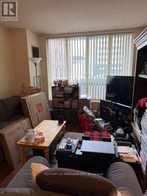 Toronto (Annex) condo for rent - A room with boxes and furniture in it.
