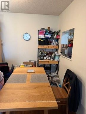 Toronto (Annex) condo for rent - A room with a wooden table and a clock on the wall.