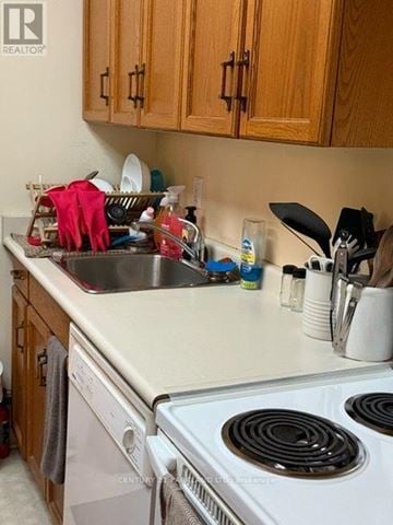 Toronto (Annex) condo for rent - A kitchen with a stove top oven and a dishwasher.