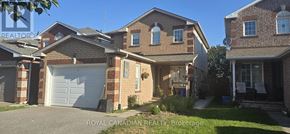 Clarington (Courtice) apartment for rent - A house with a white garage door is for sale.