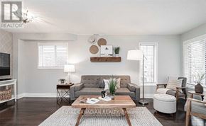 Clarington (Courtice) apartment for rent - A living room with a grey couch, a coffee table, and a rug.