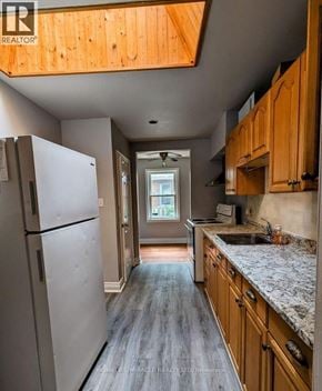 Halton Hills (Georgetown) apartment for rent - A kitchen with a refrigerator, cabinets, and a countertop.