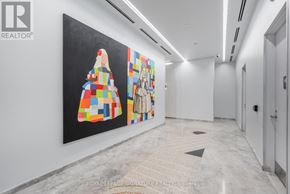 Toronto (Mount Pleasant West) condo for rent - A painting of a woman in a colorful dress is on display in a white hallway.
