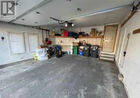 Brampton (Snelgrove) apartment for rent - A room with a concrete floor and walls, filled with various items and tools.