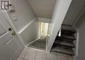 Brampton (Snelgrove) apartment for rent - A staircase in a home with a white door at the top.